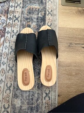 The Sak Black Slide Mules with Wood-Look Footbed